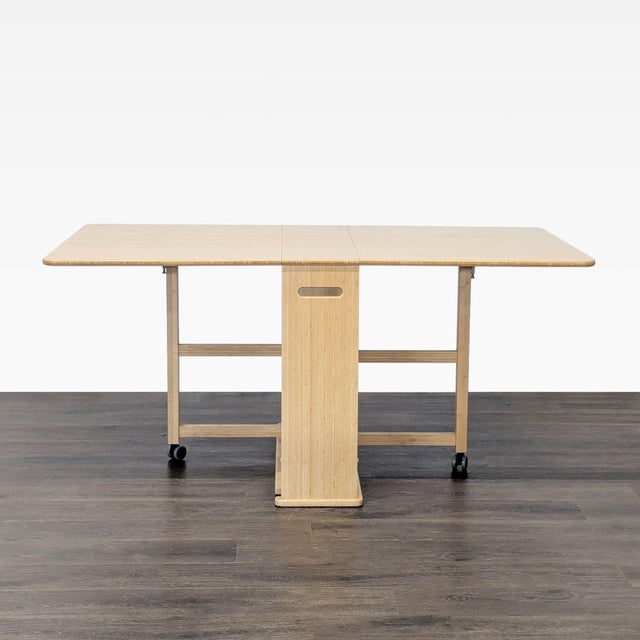 Lift the leaves and pull out the center gateleg on each side to turn the compact console into a full-size dining room...