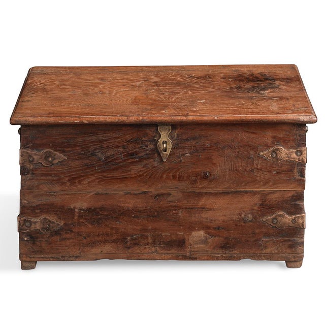 A timeless Indian wooden storage box brimming with rustic charm. Hand-crafted from solid timber with a warm, weathered...