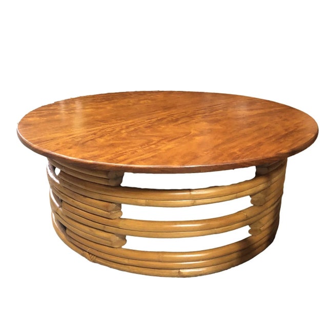 Stack round rattan coffee table, circa 1940. This rare rattan table features a unique stack rattan base made with cut-out...