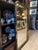 A striking vintage black lacquer Chinoiserie mirror featuring hand-painted gilt decoration inspired by traditional East...