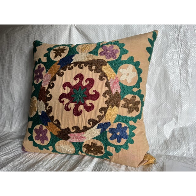 This striking pillow features Suzani textile dating to the early 1900s, beautifully repurposed into a decorative cushion....