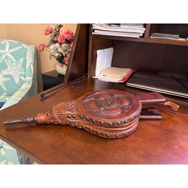 Handsome antique English fireplace bellows crafted in carved oak with richly patinated leather and extensive brass tack...