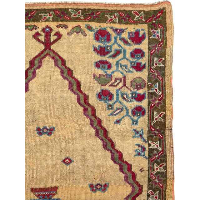 An antique Turkish Ghiordes carpet from the first quarter of the 20th century. Measures: 2' 9" x 4' 5"