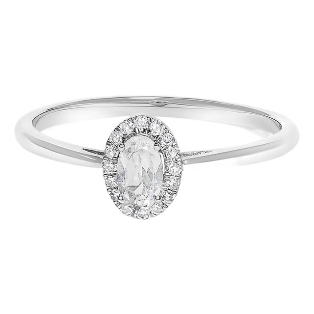 10K White Gold 5X3MM Oval White Topaz and Diamond Accent Halo Ring (I-J Color, I1-I2 Clarity) - Ring Size 5.5 For Sale