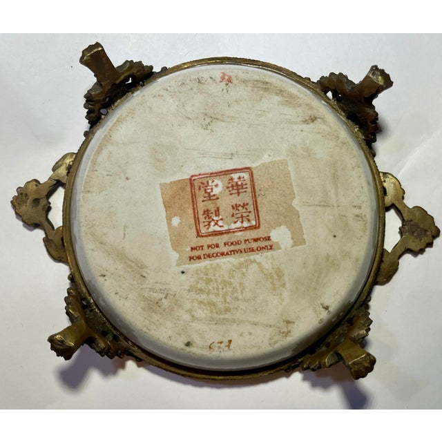 A traditional Chinese ceramic artistry with European-style bronze mounts. The 'Hua Rong Tang Zhi' mark indicates...