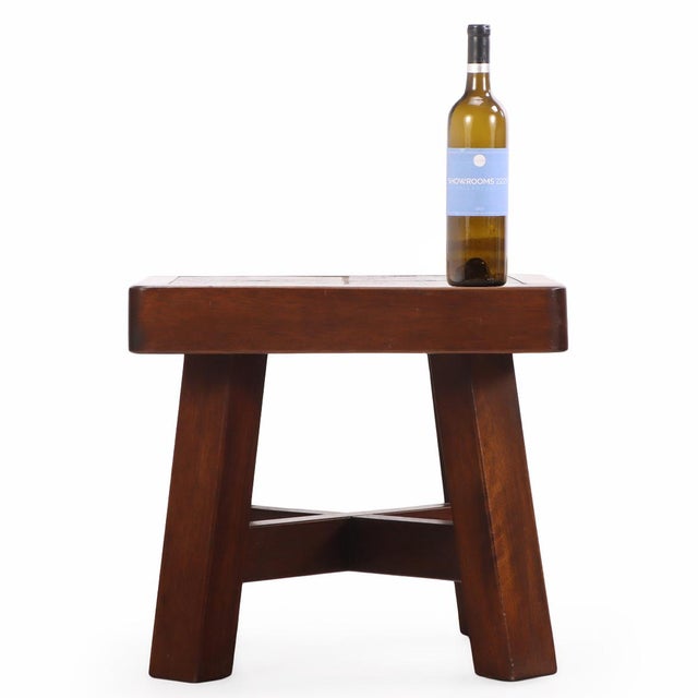 A French mahogany end table, circa 1960, executed in a Brutalist style. The table features a top composed of four square...