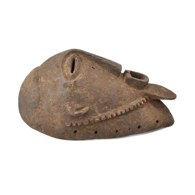 The hand-carved, wood Bembe Alunga mask originates from the Bembe people of the Democratic Republic of the Congo. Crafted...