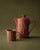 This vintage ceramic tea/coffee set from the 1970s includes a teapot with its original lid and a matching creamer, both...