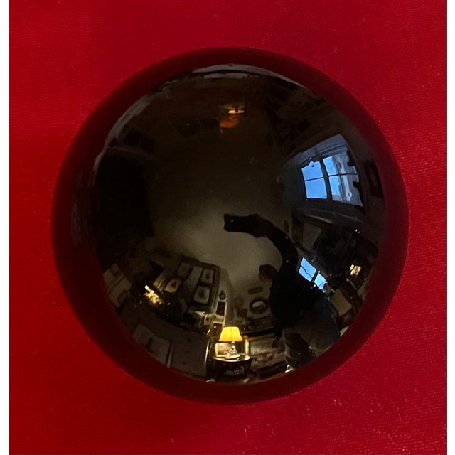 Antique 19th century American blown glass amber witch's ball. Finished with a polished pontil. Measures 6" diameter. Good...