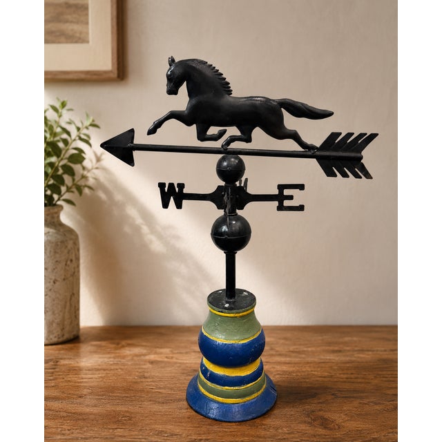 Vintage full-bodied running horse weathervane mounted on a colorful turned wooden display base. The dimensional horse is...