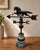 Vintage full-bodied running horse weathervane mounted on a colorful turned wooden display base. The dimensional horse is...
