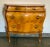 Why does a “petite bombe Italienne” make a person so happy? Is it the inlaid olive wood marquetry veneer with the dainty,...