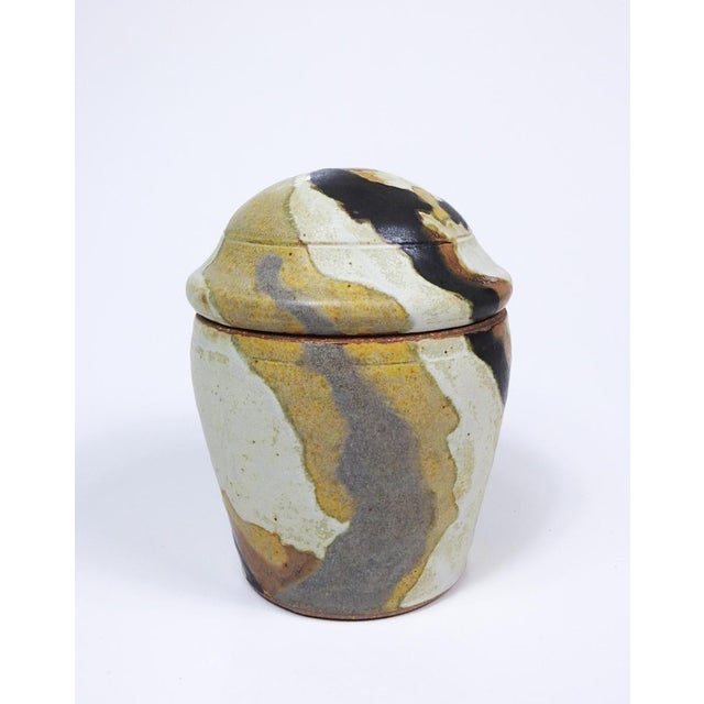 Mid 20th centery stoneware pottery lidded jar with abstract pattern earthtone glaze by Margaret "Marg" Loring (d. 1998)...