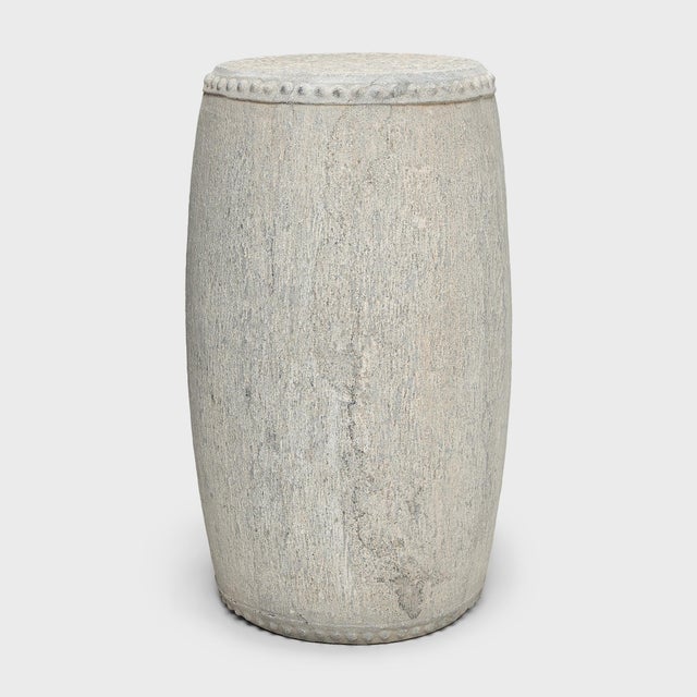 This slender stone drum stool was carved from a solid block of limestone with simple form and minimal decoration. The top...