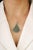 This pendant is crafted in 925 sterling silver and features a refined cluster design set with natural emeralds accented by...