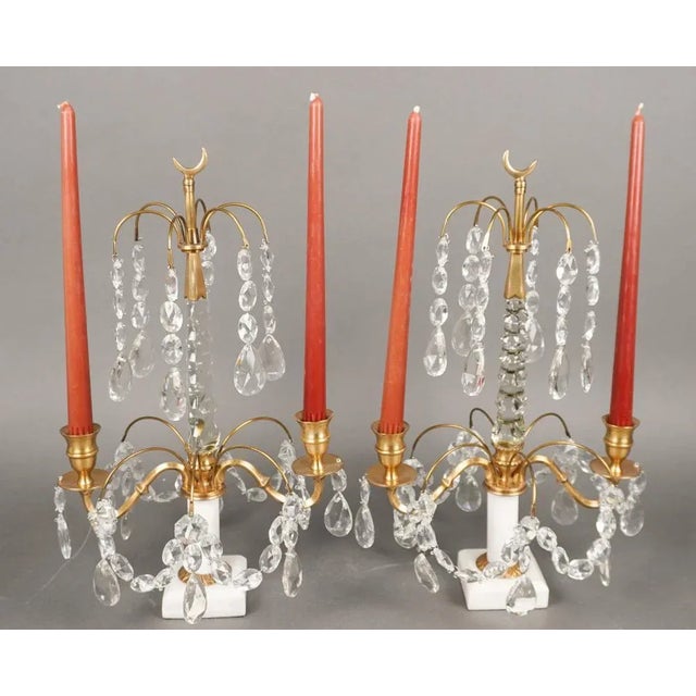 Pair Of Crystal And Brass Two arm Candle Table Sconces on Marble Plinth in great vintage condition. Measures 11" in...