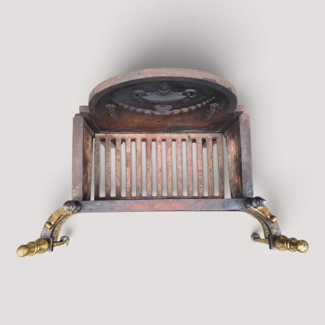Adams style cast iron grate with serpentine brass front, in original very good untouched condition. 19.5" high 26.25" wide...