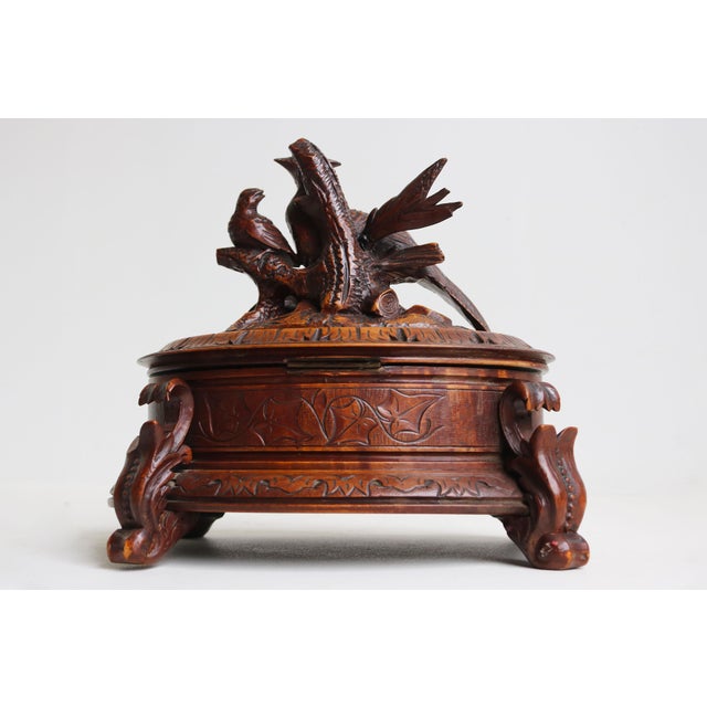 This stunning 19th-century Black Forest jewelry box from Switzerland is a true work of art, featuring a rare oval shape....