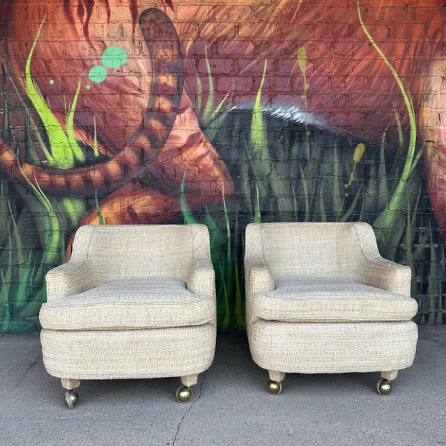 This is a pair of Edward Wormley for Dunbar club chairs. They feature a rounded shape, stubby upholstered legs on casters,...