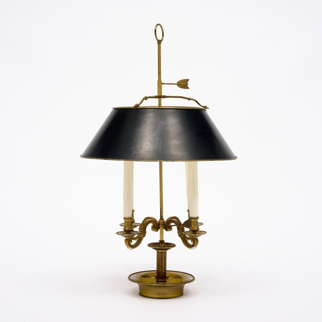 Bouillotte lamp from France in the French Empire style. This piece is made of finely cast bronze and features four...