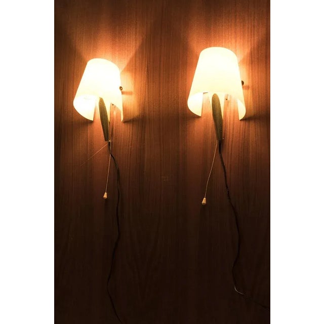 Beautiful pair of wall lamps made out of brass and yellow polyester from the '50s. In good vintage condition. Measurements...