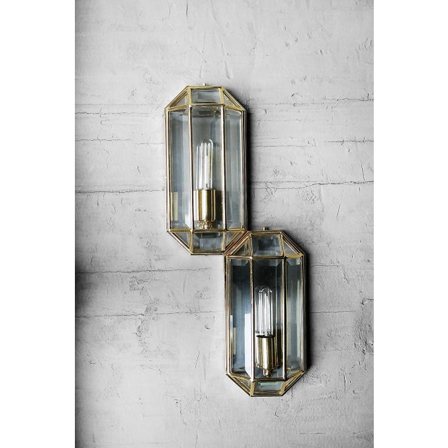 This set of two geometric wall lamps was manufactured in Italy during the 1970s. It has a three-dimensional form. The...