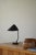 Rare and elegant adjustable table lamp in black lacquered metal from the 1950s. Made by the Danish company Louis Poulsen....