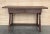A charming early 20th century Spanish pine farm table with four legs and back side trestle and a wonderfully well-worn...