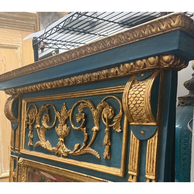 This is a monumental Italian neoclassical trumeau mirror with Louis XVI styling. It has beautiful carved applied giltwood...