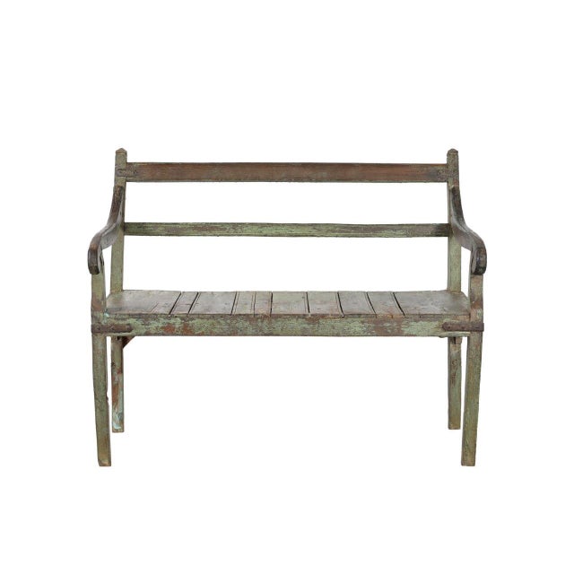 This Vintage Indian Painted Teakwood Bench is handcrafted from solid teakwood and showcases a beautifully weathered...