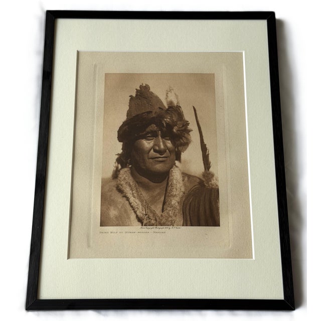 This striking 1909 photogravure, Packs Wolf as Numak‑mahana, presents a Mandan/Arikara figure with ceremonial regalia that...