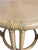 Small round tables made of curved wicker bamboo-look wood, with a light wood top. Natural tan color.