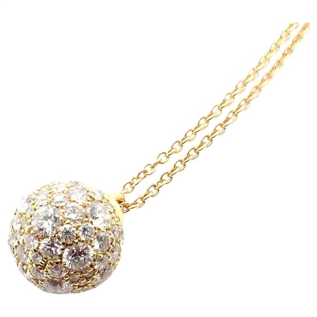 This Tiffany & Co. pendant necklace showcases a dazzling diamond-encrusted ball on a delicate 18k yellow gold chain....