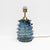 Elegant pair of table lamps featuring cylindrical bodies crafted from blue-coloured Murano glass using the refined...