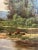American school oil on canvas made in the 19th Century depicting a fisherman on a pond fishing on his own, conveying a...