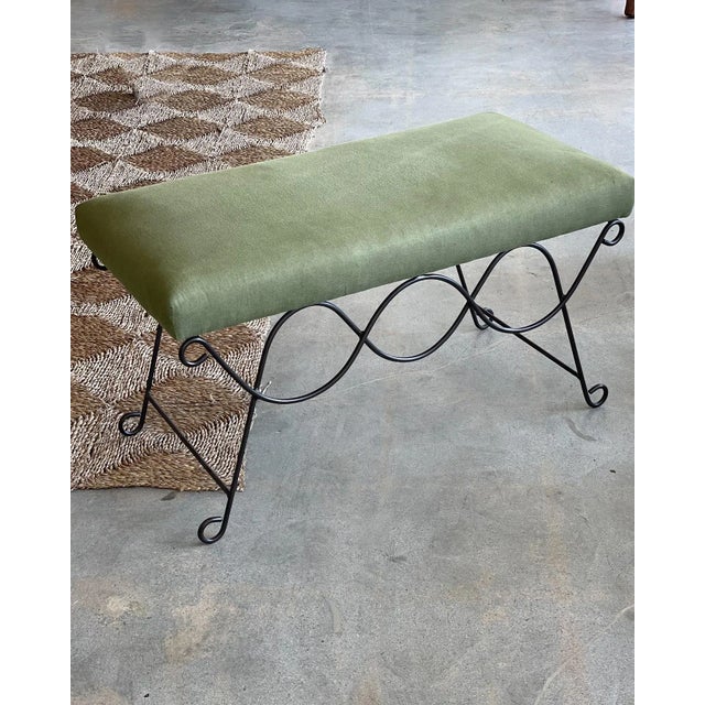 Iron bench with beautiful curved and looped base with matte black painted finish. Rectangular cushioned seat upholstered...