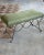 Iron bench with beautiful curved and looped base with matte black painted finish. Rectangular cushioned seat upholstered...
