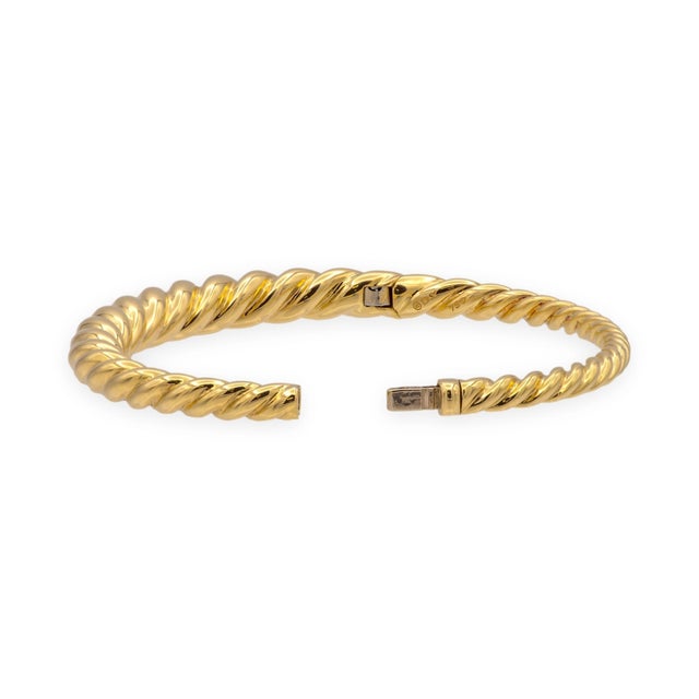 David Yurman hinged bangle in 18K yellow gold from the Pure Form collection, featuring the brand's signature twisted cable...