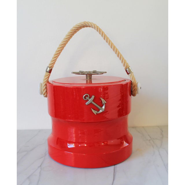 Vintage red nautical themed ice bucket with rope handle, anchor, and ship helm. Made in the USA by Shelton Ware. Some age...