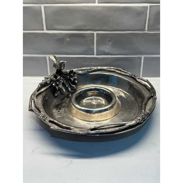 Beautiful chip and dip server featuring a branch around the rim and a sweet little bird sitting atop. Made of cast metal.