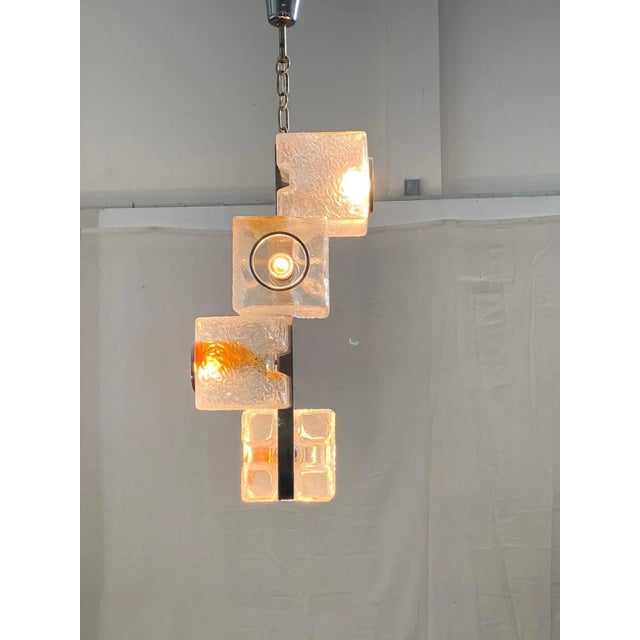 Chandelier by Toni Zuccheri for Veart 1970. Central steel profile, supports 4 cubes in coloured filiform glass 16x16 cm....