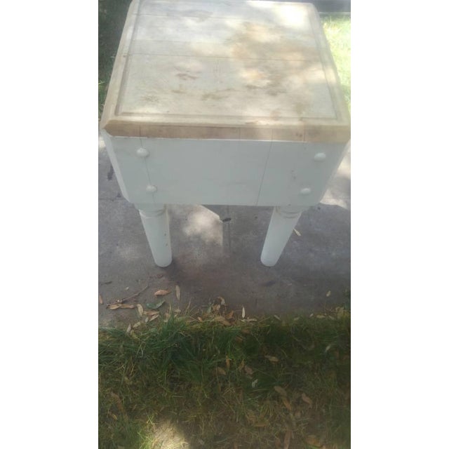 Hi, cute vintage cream colored cutting block butcher block table. Measures about 32 in tall by 23 in wide by 23 in deep....