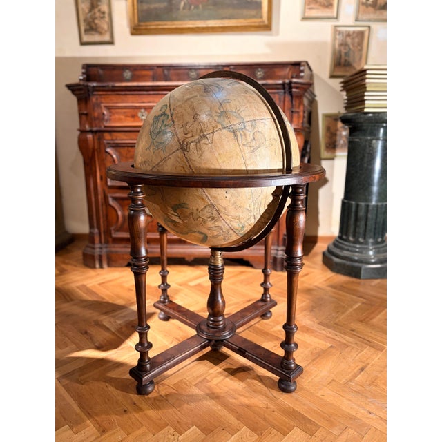 This 19th-century antique Italian celestial globe on a turned wood floor stand is a captivating decorative statement...