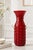 Striking vintage red glass vase featuring two sculptural clear glass handles, in the distinctive style of Italian mid-...