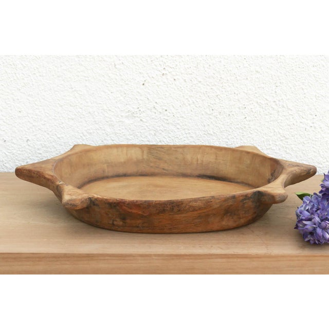 The sculptural form of this vintage bowl takes center stage. Carved from a single piece of solid hardwood, it features a...