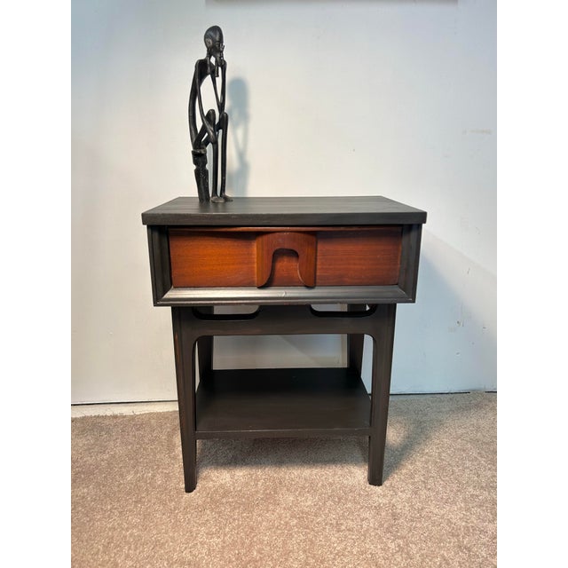This cute MCM nightstand has wonderful details. The drawer is walnut or mahogany veneered with a unique wooden horseshoe...
