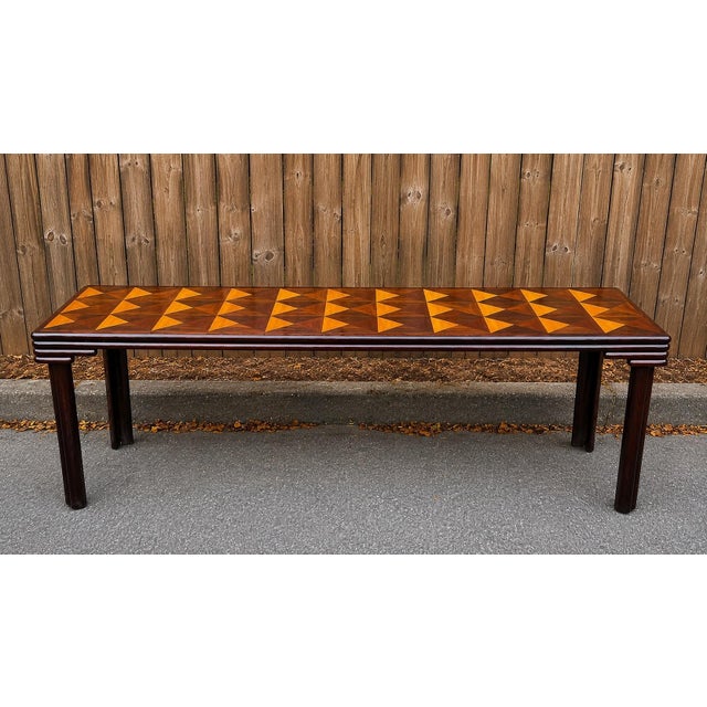 This is a monumental artisan crafted post-modern mahogany marquetry inlaid console or dining table. The elaborate...
