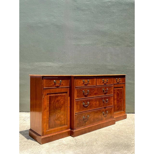 This vintage flame mahogany sideboard cabinet is a refined example of mid-20th century craftsmanship, distinguished by its...