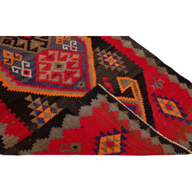 Beautiful vintage Turkish Kilim hand-knotted wool rug with a tan field. This piece has a tan frame and multicolor accents...