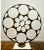 Large iron abstract sculpture on iron base. Cutout circles and interdispersed geometric shapes.
